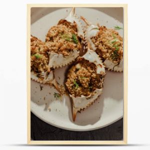 Close up of stuffed blue crabs on white plate