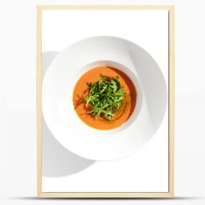 Summer Spanish soup - gazpacho with rocket salad isolated on white background. Vegetarian cold tomato soup in white plate. Meatless food in menu. Veggie lunch. Healthy food. Plant based eating.