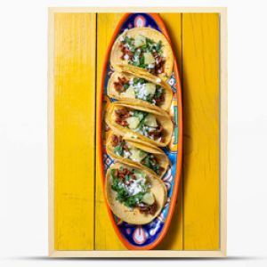 Mexican background with tacos al pastor and mexican sauces. Yellow wooden background, copy space, top view