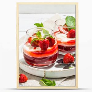 Italian dessert panna cotta in glass with strawberries. Healthy sweet food, hard light, dark shadow