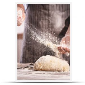 hands of baker's male knead dough