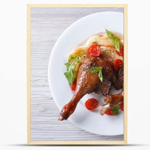 duck legs baked with apples and tomatoes  close-up top view