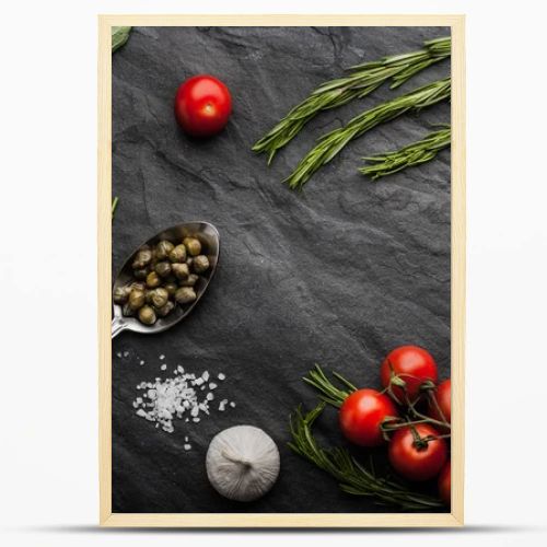 Herbs mix with tomatoes and olive oil on the black stone table
