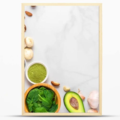 Healthy vegan food clean eating selection: fruit, vegetable, seeds, superfood, nuts, berries on white marble background