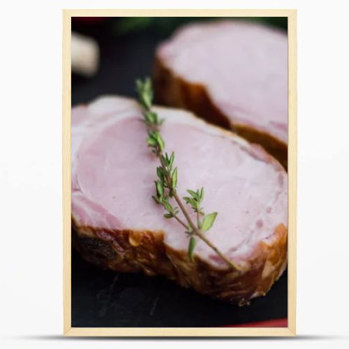 Smoked pork ribs with vegetables on a black stone background. Top view. Close-up