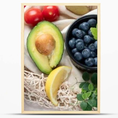 Healthy food selection on white wooden background . Fresh fruits , superfoods an vegatables . High in antioxidants, vitamins, minerals, fiber. Top view , panorama