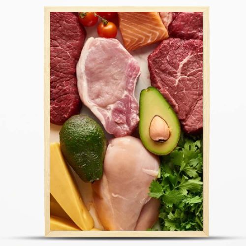 Top view of assorted raw meat, poultry, fish, eggs, vegetables, fruits, nuts, greenery and cheese 