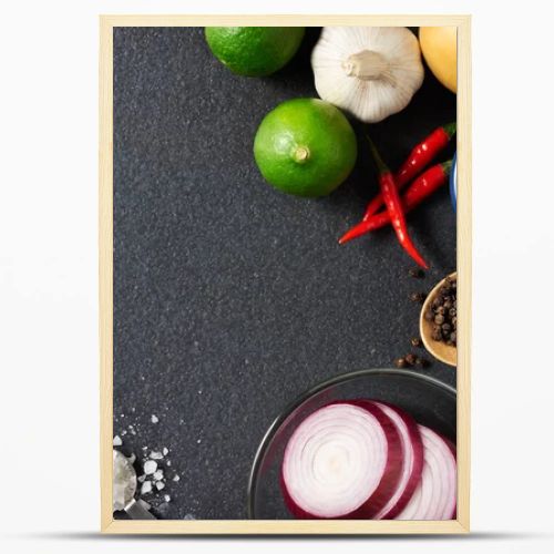 Spices and food ingredients on slate background with copy space