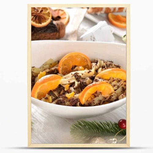Top view of a bowl of noodles with poppy seeds and dried fruits as a traditional Polish dessert for Christmas Eve's supper