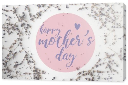 top view of mothers day greeting with frame of lavender flowers on white tabletop