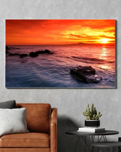 Amazing sunset over rocky seascape