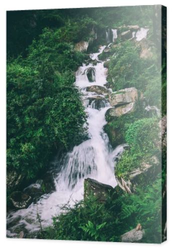 amazing waterfall with rocks and green plants in indian himalayas
