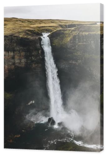 aerial view of icelandic landscape with Haifoss waterfall and green hills