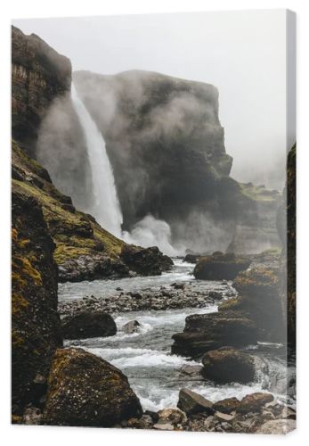 dramatic icelandic landscape with Haifoss waterfall on misty day