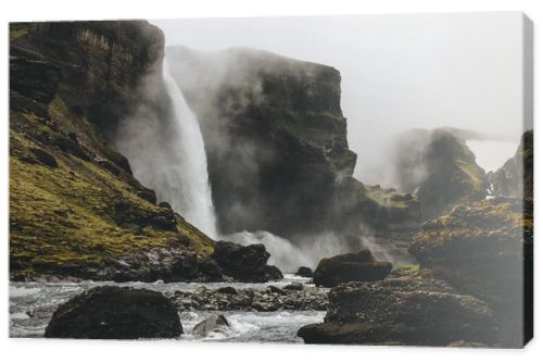 beautiful icelandic landscape with Haifoss waterfall on misty day