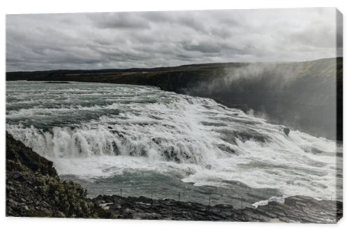 aerial view of beautiful Gullfoss waterfall under cloudy sky in Iceland