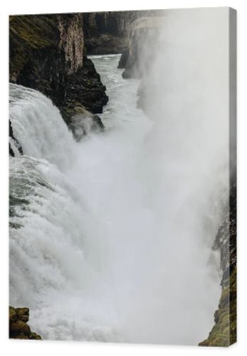 aerial view of steam above beautiful Gullfoss waterfall flowing through highlands in Iceland