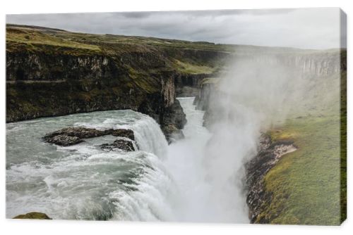 scenic view of steam above beautiful Gullfoss waterfall  flowing through highlands in Iceland