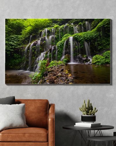 Tropical landscape. Beautiful hidden waterfall in rainforest. Adventure and travel concept. Nature background. Slow shutter speed, motion photography. Banyu Wana Amertha waterfall Bali, Indonesia