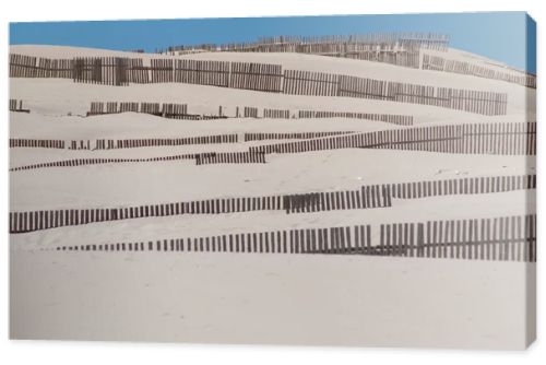 Wooden fences on deserted beach dunes in Tarifa, Spain