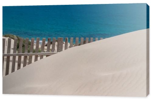 Wooden fences on deserted beach dunes in Tarifa, Spain