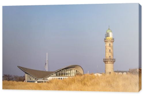 Lighthouse in Warnemuende, Germany with marram grass on sand dunes on the foreground. High quality photo