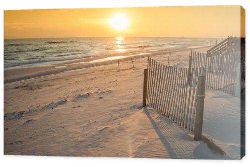 Beautiful Sunset Over the Ocean with Sand Fencing