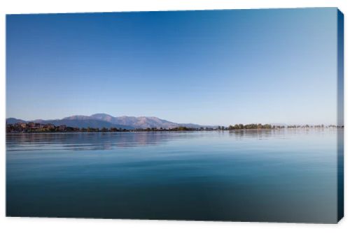 beautiful landscape with tranquil water and green vegetation on coast at sunny day, egirdir,  turkey