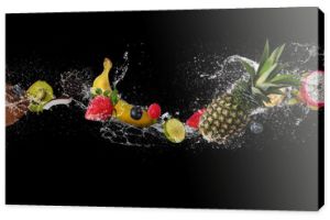 Pieces of fruit in water splash, isolated on black background