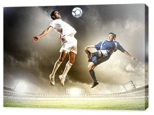two football players striking the ball