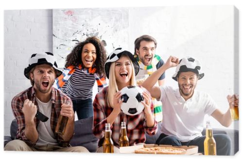 cheerful multicultural football fans shouting while watching championship at home