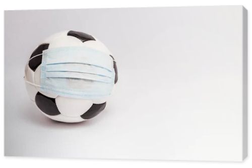 soccer ball in medical mask on white with copy space