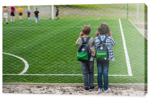 schoolboys on soccer field 