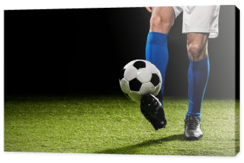 cropped view of man playing with ball on grass isolated on black