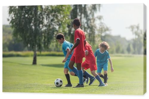 cute kids playing football with african american friend 