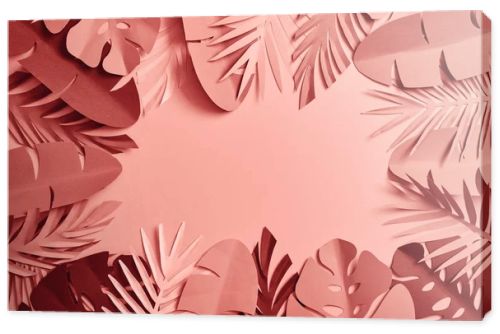 top view of tropical paper cut palm leaves on pink background