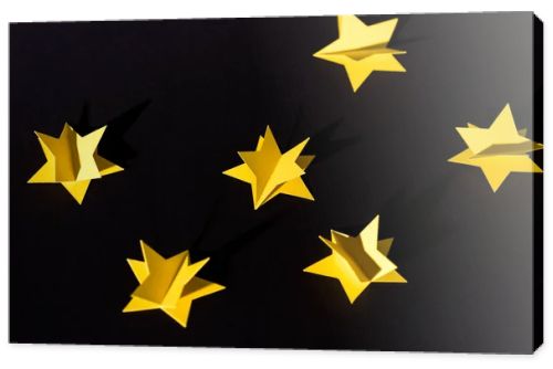 decorative yellow paper stars isolated on black 