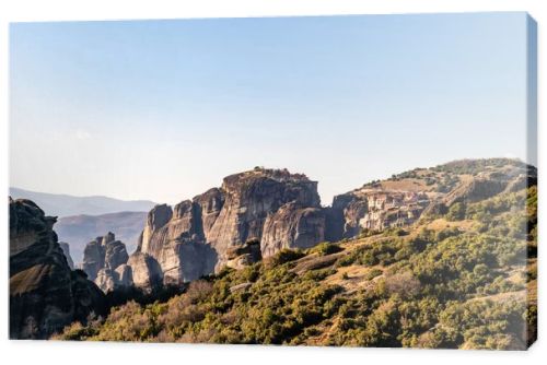 rock formations with monastery near mountains in meteora 