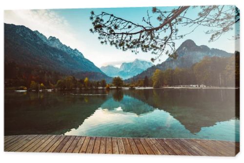 Jasna lake with beautiful reflections of the mountains and wooden pier. Triglav National Park, Slovenia