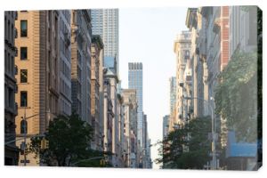 View down Fifth Avenue in Manhattan, New York City with historic buildings lining both sides of the street in NYC