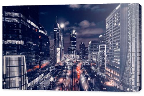 Beautiful panoramic aerial drone skyline view of the center of night Warsaw with skyscrapers in the background on avenues of John Paul II - the lights of the big city by night, Poland, EU.