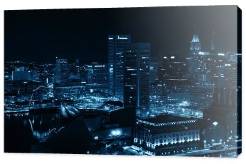 Baltimore inner harbor district rooftop view at night with urban buildings.