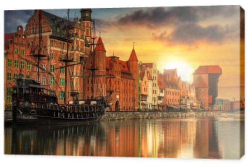 Beautiful old town with historical port crane in Gdansk over Motlawa river at sunset, Poland.