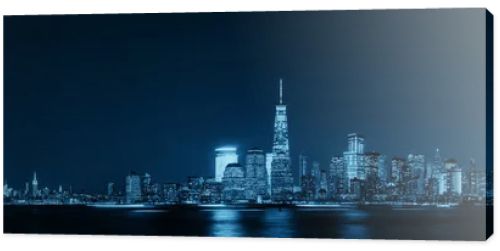 New York City skyline with skyscrapers over Hudson River viewed from New Jersey at night