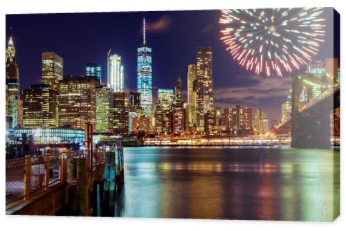 Firework over city at night with reflection in water