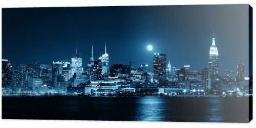 Moon rise over midtown Manhattan with city skyline at night