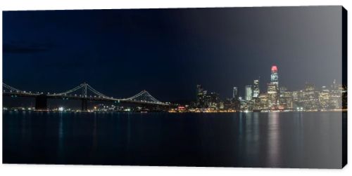 Light illuminates the beautiful Northern California city of San Francisco at night. This scenic, modern metropolis is located on the edge of the Pacific Ocean and just west of the city of Oakland.