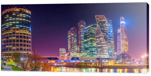 Panorama of Moscow City with reflections in Moscow river at night. Modern architecture of Russia