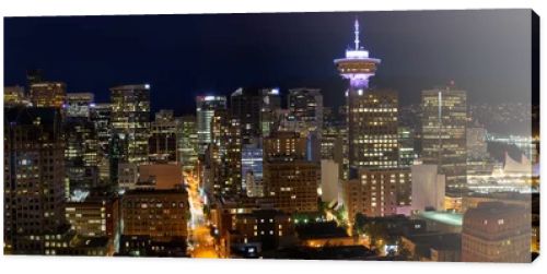 Beautiful panoramic view of the modern cityscape from an aerial perspective at night. Taken in Downtown Vancouver, BC, Canada.
