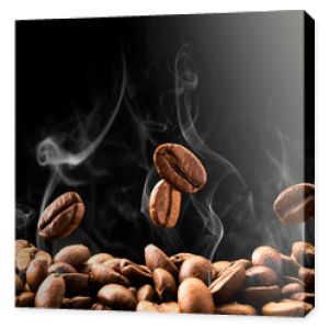Coffee beans fall in smoke on a black background. Roasting coffee